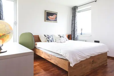 a bedroom with a large bed with a wooden frame at Vila Izabela in Križevci pri Ljutomeru