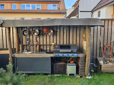an outdoor kitchen with a stove in a backyard at Apartment Slavija in Škofja Loka