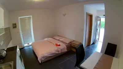 a bedroom with a bed with two pink pillows at Apartma Jernej in Bovec