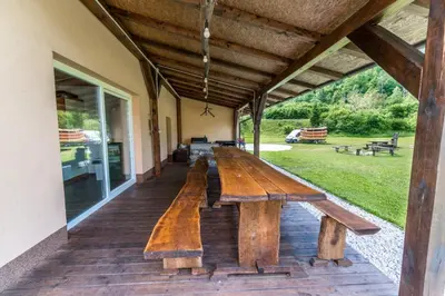 a wooden bench on the porch of a building at Apartma Jernej in Bovec