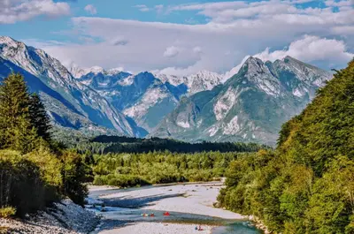 a river in a valley with mountains in the background at Apartma Jernej in Bovec