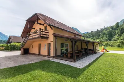 a house with a large yard with a patio at Apartma Jernej in Bovec