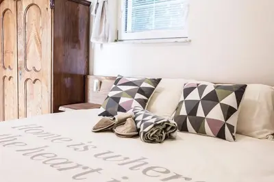 a bed with pillows and shoes sitting on it at Terasse Jeruzalem Apartments in Hermanci