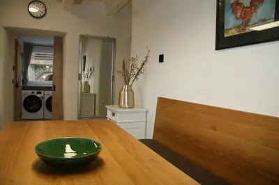 a green bowl sitting on top of a wooden table at Terasse Jeruzalem Apartments in Hermanci