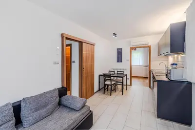 a living room with a couch and a kitchen at Penzion Hosnar, apartma Time Out in Bovec