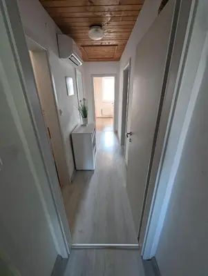 a hallway of an empty room with a table at Apartment Bee near Bled in Zabreznica