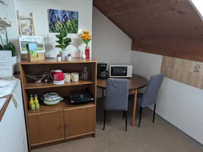 a room with a table and chairs and a kitchen at Apartment Bee near Bled in Zabreznica