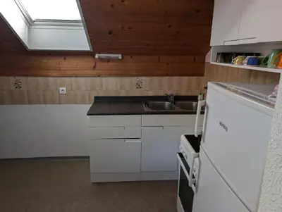 a kitchen with white cabinets and a sink and a window at Apartment Bee near Bled in Zabreznica