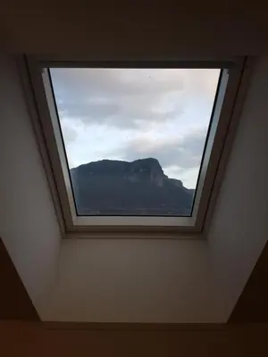 a window in a room with a view of a mountain at Apartmaji Zupan in Bohinjska Bela