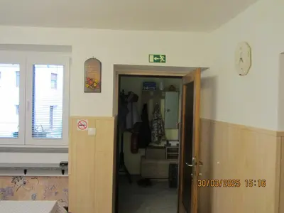 a room with a hallway with a door and a room with a clock at Apartma Vilma in Kobarid