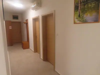 a hallway with two doors and a painting on the wall at Apartma Kolpa in Gradac