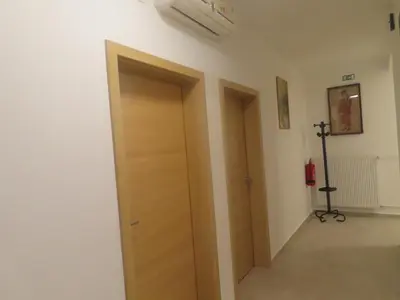 a hallway with a wooden door in a room at Apartma Kolpa in Gradac