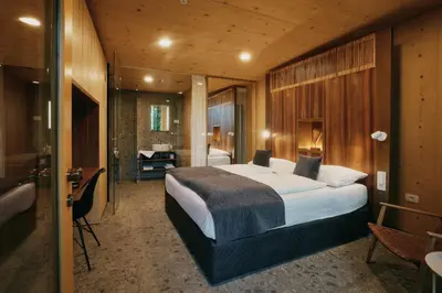 a bedroom with a large bed and a bathroom at Theodosius Forest Village - Glamping in Vipava valley in Vipava