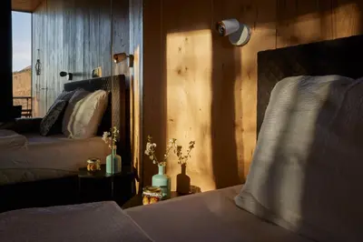 a bedroom with two beds and a window at Theodosius Forest Village - Glamping in Vipava valley in Vipava