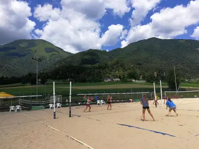 a group of people playing volleyball on a beach at River house HRIB in Preddvor