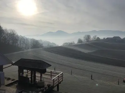 a view of a farm field with the sun in the sky at Tourist farm Artisek in Štore