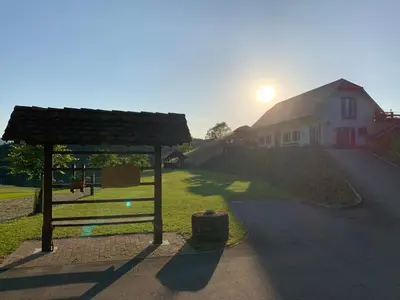 a gazebo in front of a house at Tourist farm Artisek in Štore