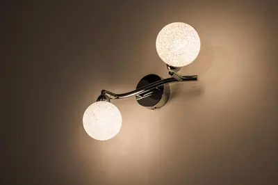 a pair of lights hanging on a wall at Golf apartment with SPA tickets discount in Moravske Toplice