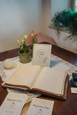 an open book sitting on a table with papers at Apartments Možinetova hiša in Šentjošt nad Horjulom