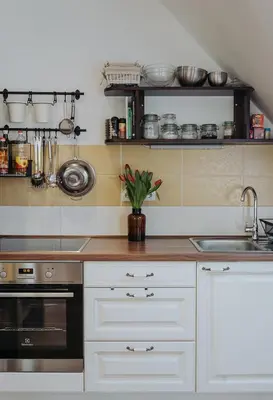 a kitchen with white cabinets and a sink and a stove at Apartments Možinetova hiša in Šentjošt nad Horjulom