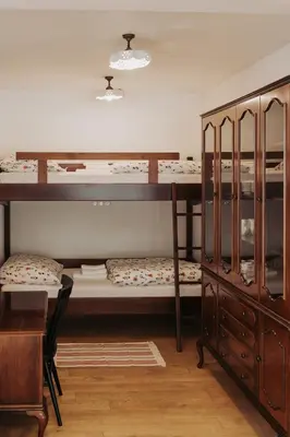 a room with two bunk beds and a desk at Apartments Možinetova hiša in Šentjošt nad Horjulom
