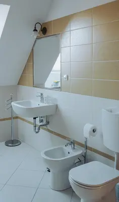 a bathroom with a sink and a toilet and a mirror at Apartments Možinetova hiša in Šentjošt nad Horjulom