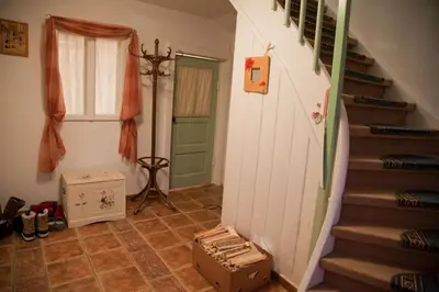 a room with a staircase and a green door at The 1882 Old House Vodnikova in Bohinj