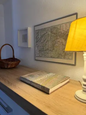 a book on a desk with a lamp and a map at Villa Dei Sogni in Bled