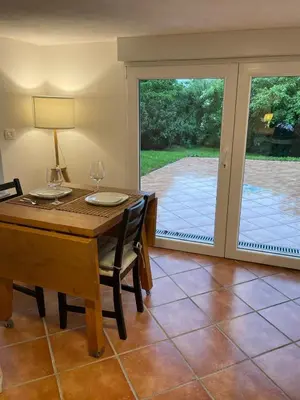 a dining room with a table and chairs and a sliding glass door at Villa Dei Sogni in Bled