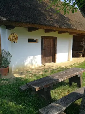 a wooden bench sitting in front of a building at Hrgova hiška in Ptuj