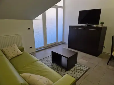 a living room with a couch and a flat screen tv at Klass 302 in Kranjska Gora