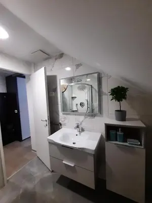 a bathroom with a sink and a mirror at Klass 302 in Kranjska Gora