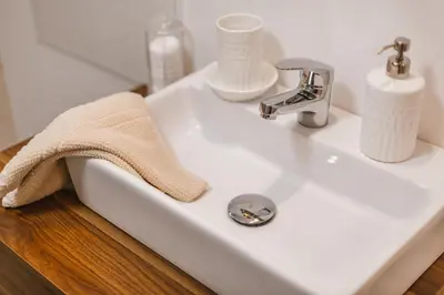 a white bathroom sink with a towel on it at Apartma Amelie & Studio Mimi Bled in Bled