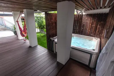 a hot tub on the deck of a house at Apartma Amelie & Studio Mimi Bled in Bled