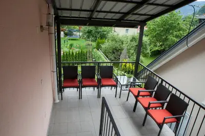 a balcony with chairs and a table with a view at Luxury apartment Karolina in Bled