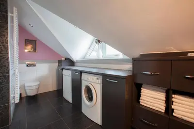 a laundry room with a washer and dryer at Luxury apartment Karolina in Bled