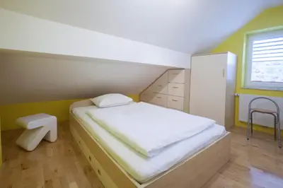 a small bedroom with a bed and a window at Luxury apartment Karolina in Bled