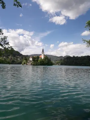a church on an island in the middle of a lake at Apartments Justin in Bled