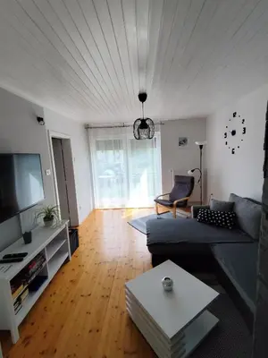 a living room with a couch and a tv at Apartments Justin in Bled