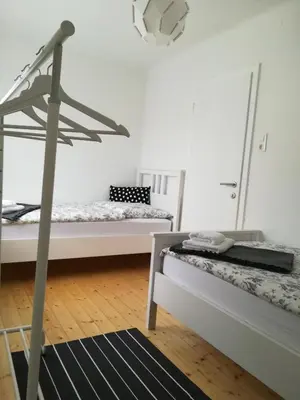 a room with two beds and a chandelier at Apartments Justin in Bled