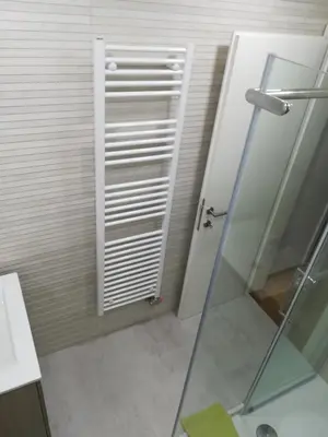 a bathroom with a shower and a glass door at Apartments Justin in Bled