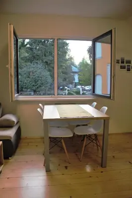 a table and chairs in a room with a window at Mariana Apartment in Bled