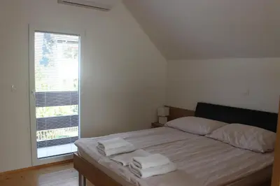 a bedroom with a bed with two towels on it at Mariana Apartment in Bled