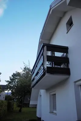 a balcony on the side of a white building at Mariana Apartment in Bled