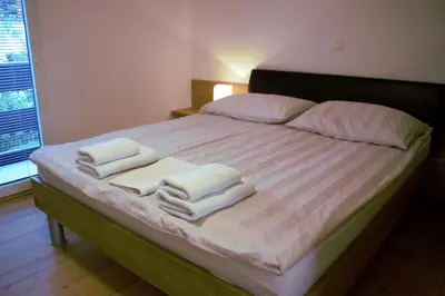a bedroom with a bed with three towels on it at Mariana Apartment in Bled