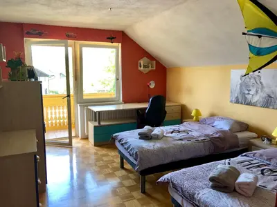 a bedroom with two beds and a desk in it at Apartma AS in Bled