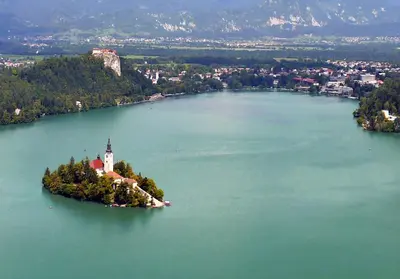 an island with a church in the middle of a lake at Apartma AS in Bled