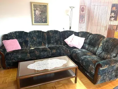 a living room with a leather couch and a table at Pr' Grogori in Železniki