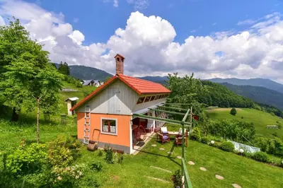 a small house on a hill in a field at Pr' Grogori in Železniki