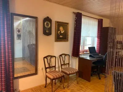 a room with a desk and two chairs and a computer at Pr' Grogori in Železniki